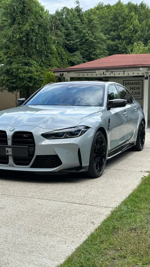 Light grey BMW M3 with black wheels outside the studio