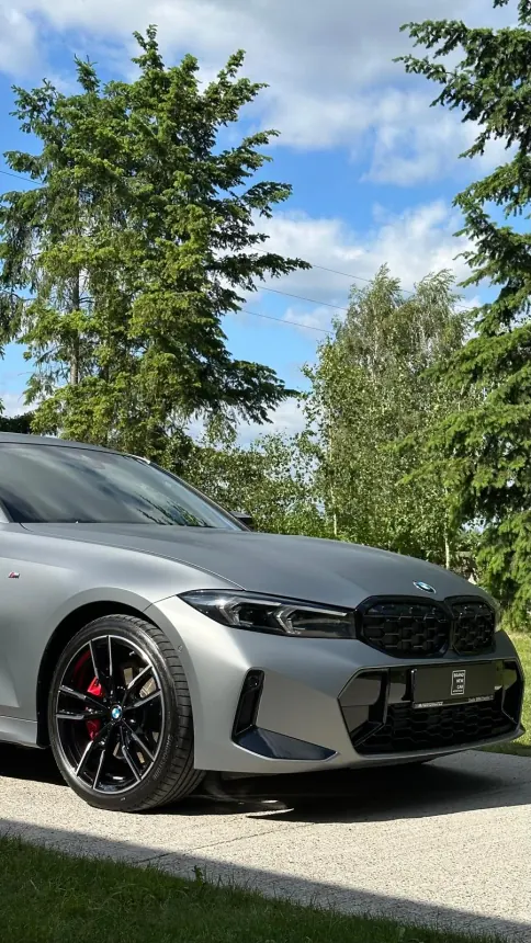 Front of a silver BMW and a black wheel