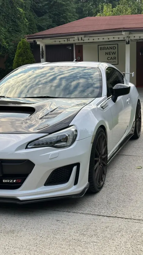 White Subaru BRZ with a dark bonnet and rear spoiler
